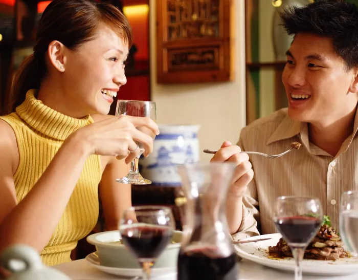 Young couple laughing at a restaurant