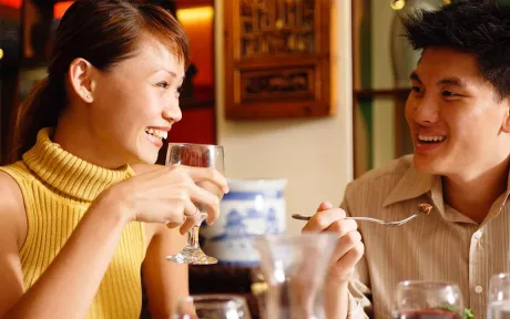 Young couple laughing at a restaurant